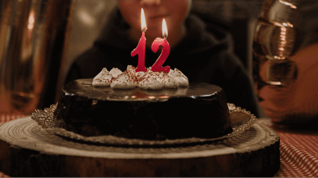 12 year old birthday cake with candles.
