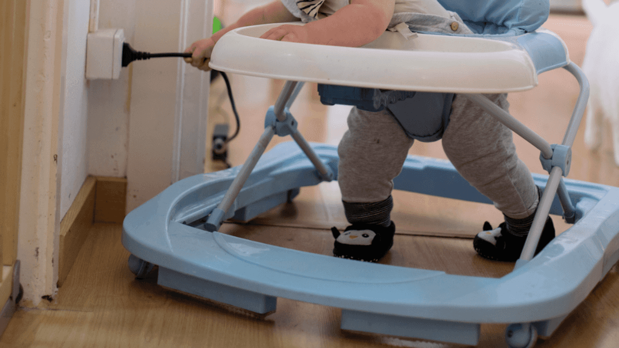 A baby pulling an electrical chord.