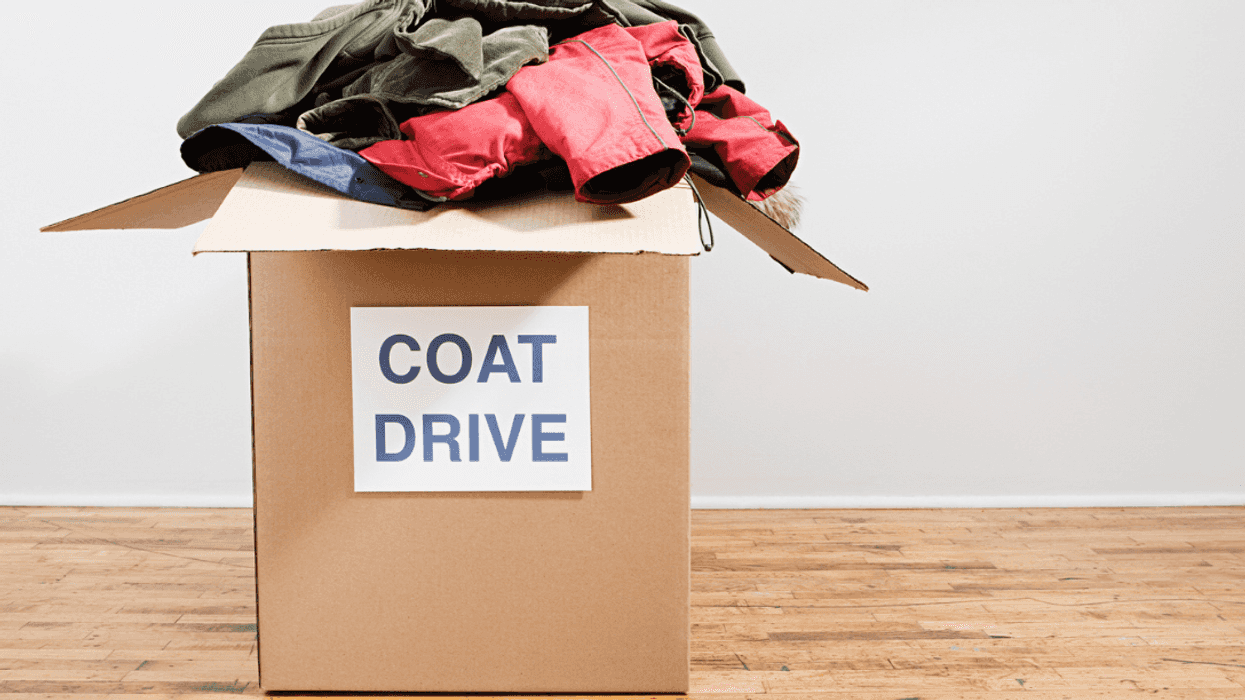 A box full of coats with a coat drive label on it