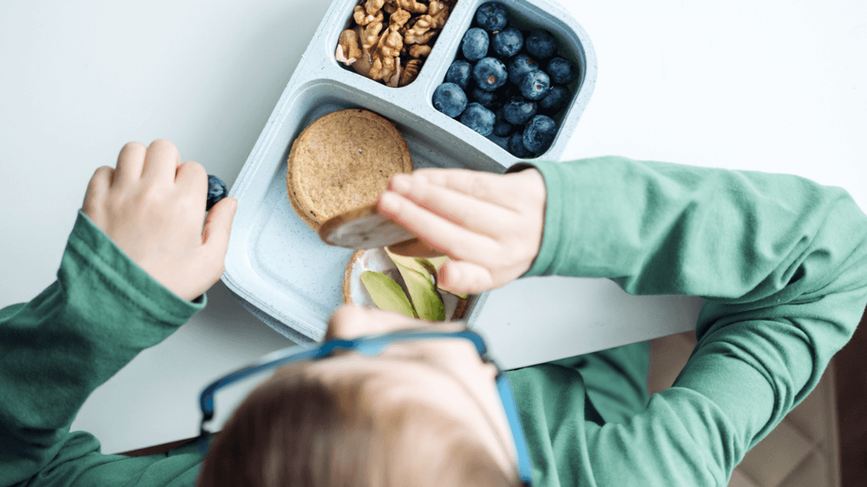 A boy eating from a lunchbox