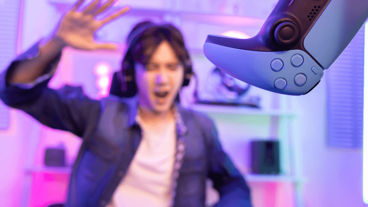 A boy throwing a video game controller.