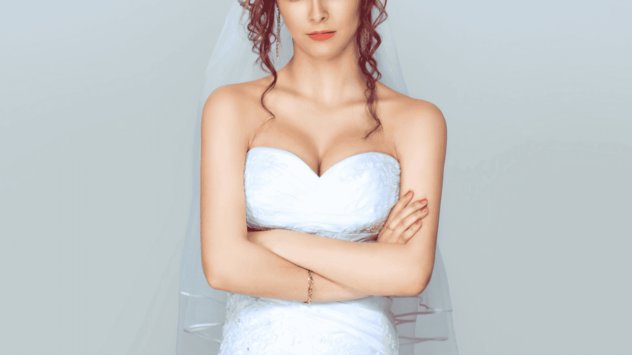 A bride with her arms crossed.