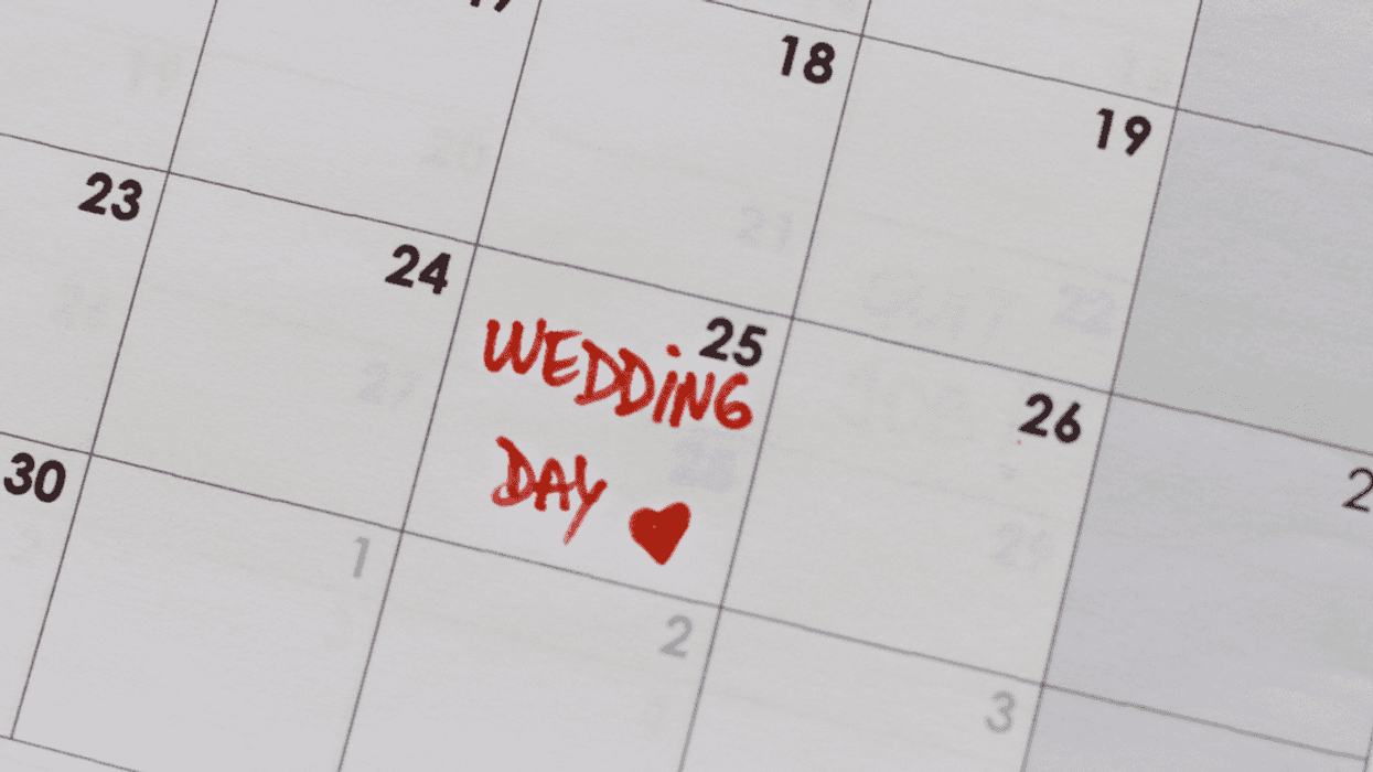 A calendar with "wedding day" written on the 25th.