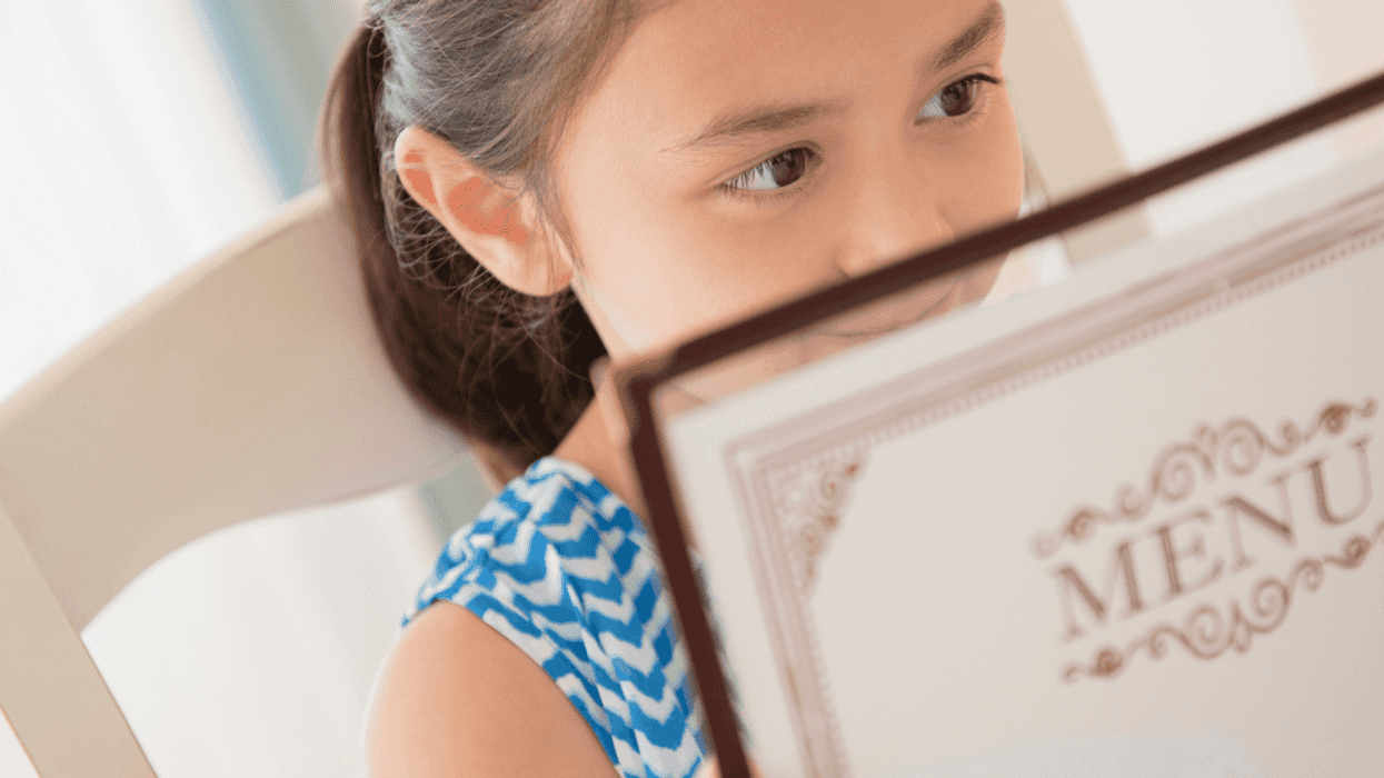 A child looking at a restaurant menu