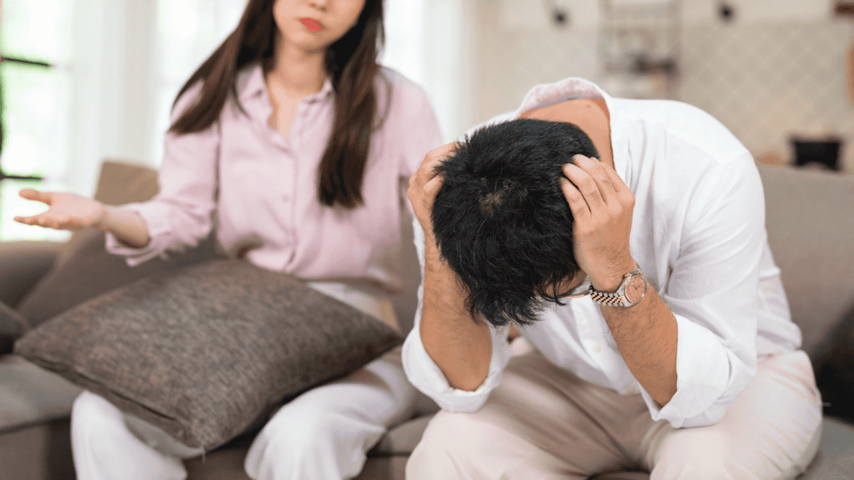 a couple fighting with a woman with her hands out and a man's head in his hands.