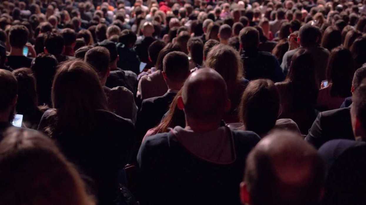 A crowd of people watch a concert