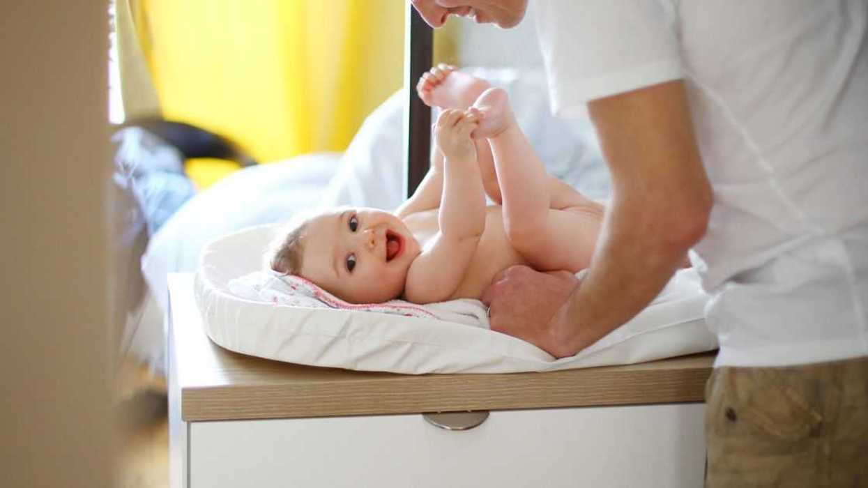 A dad with his baby on the changing table