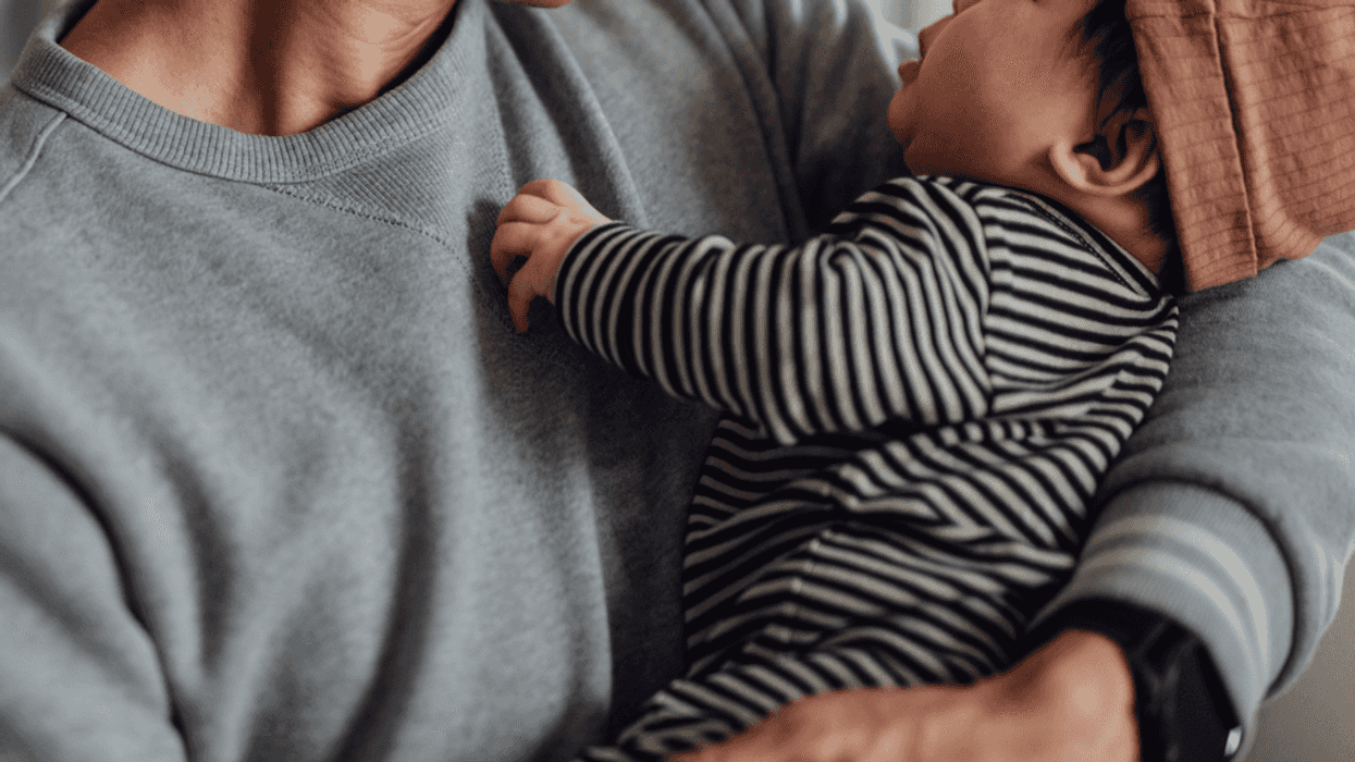 A father holding a baby.