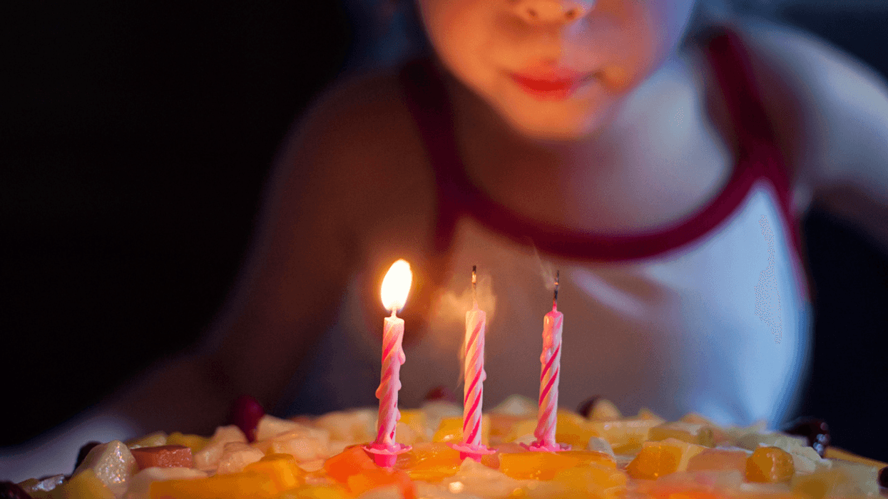 A girl and her birthday cake