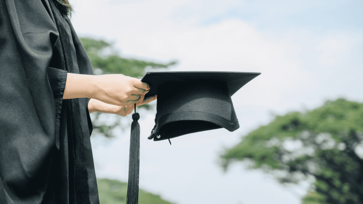 A girl wearing a graduation cap and gown.