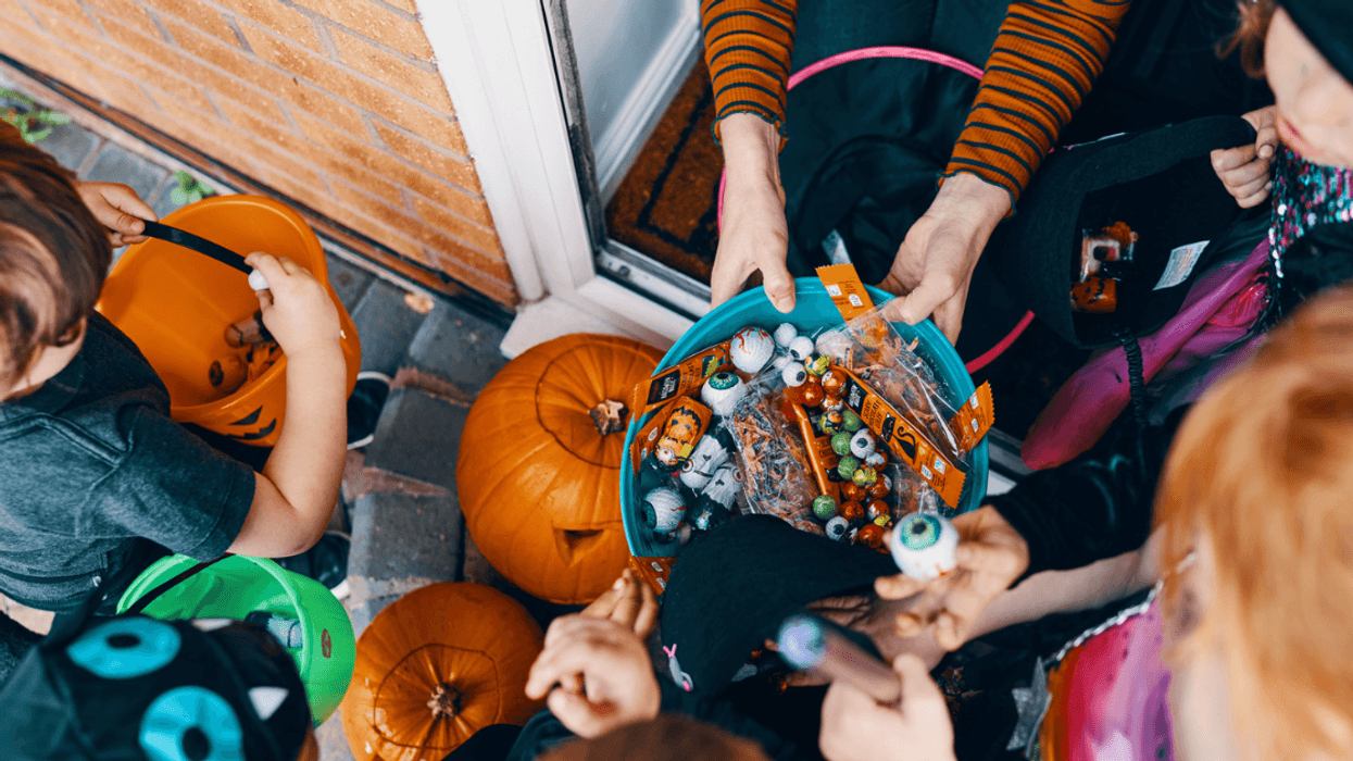 A group of children triick or treating.