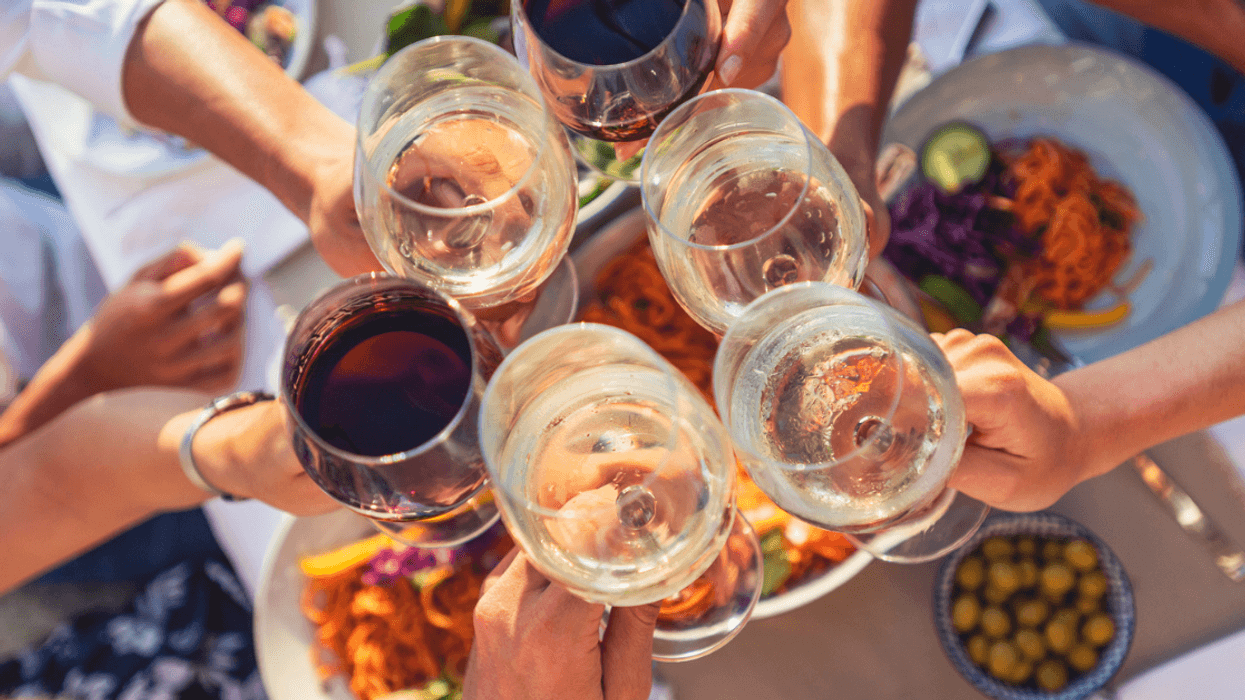 A group of people clinking wine glasses.