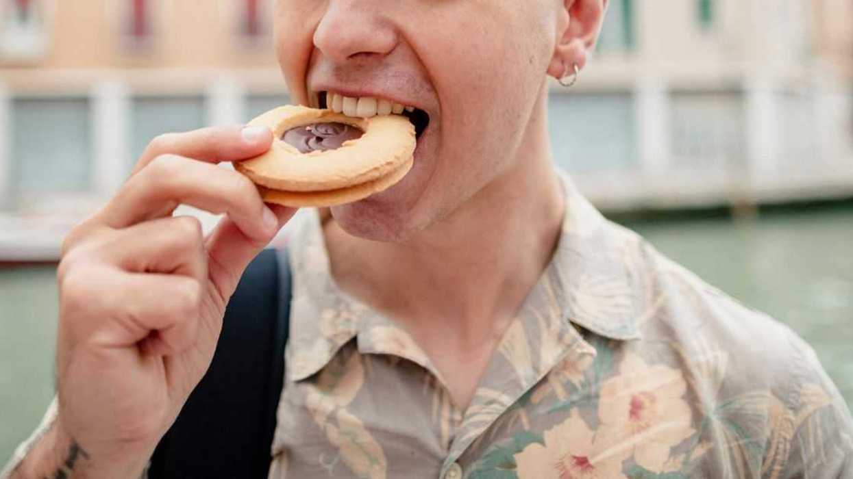 A guy eats a cookie