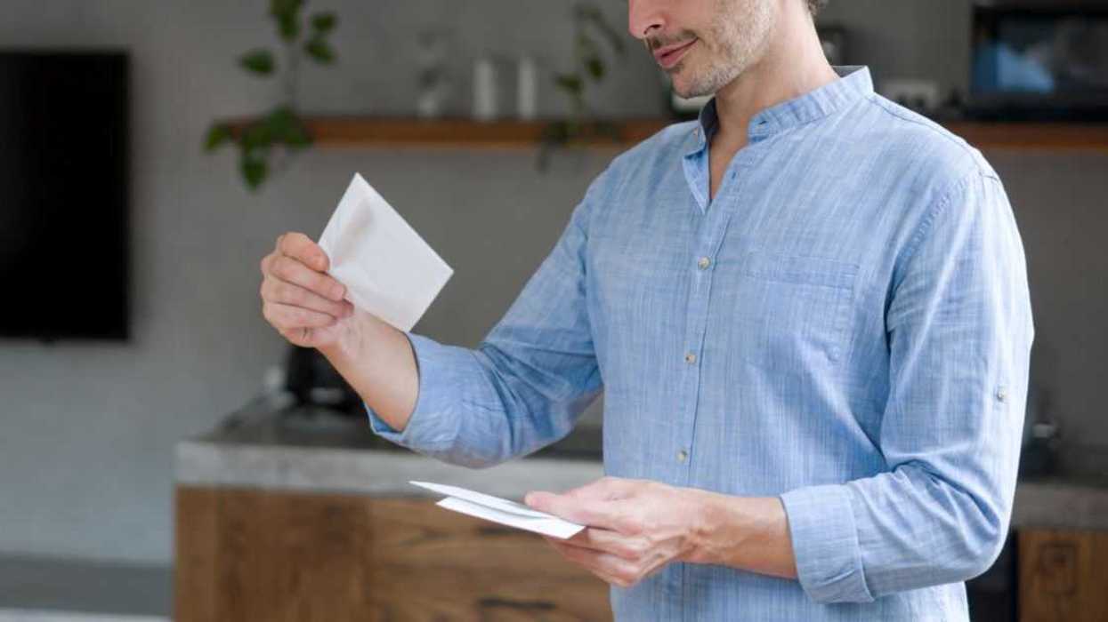 A guy looks through the mail