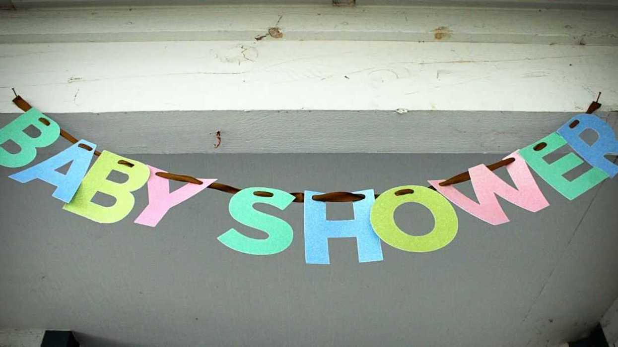 A hung sign announcing a baby shower.