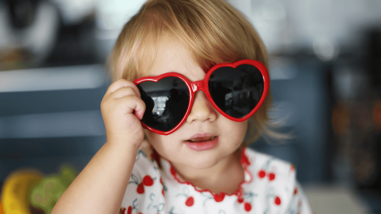 A little girl with heart shaped sunglasses.