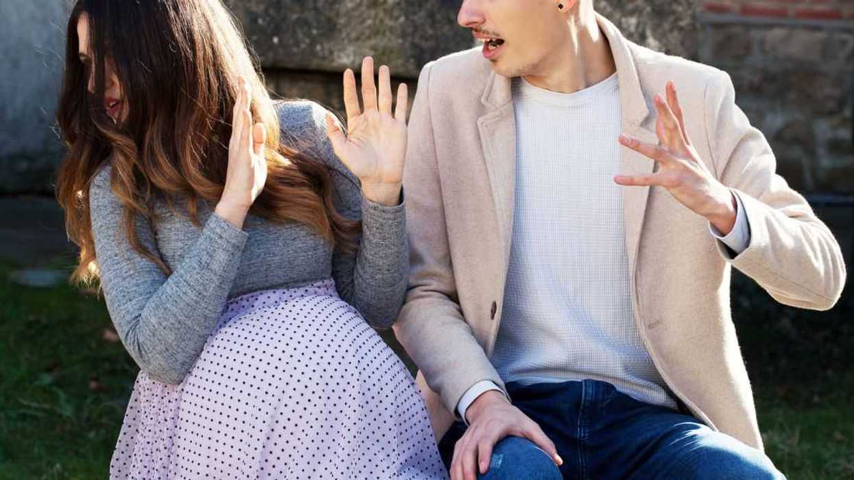 A man and pregnant woman argue