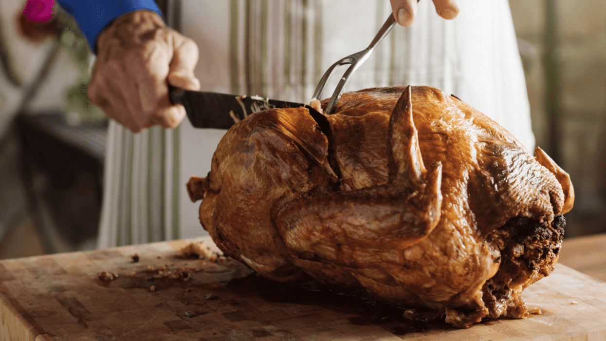A man carving a turkey.