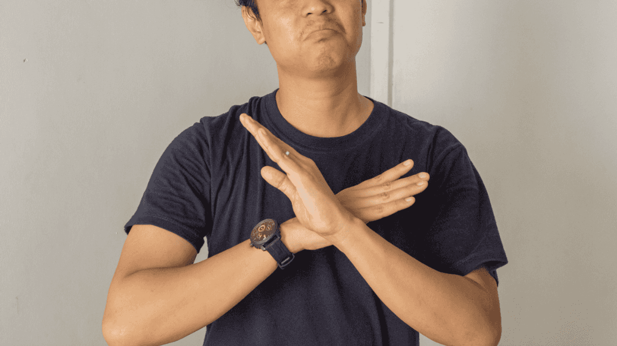A man crossing his arms across his chest.