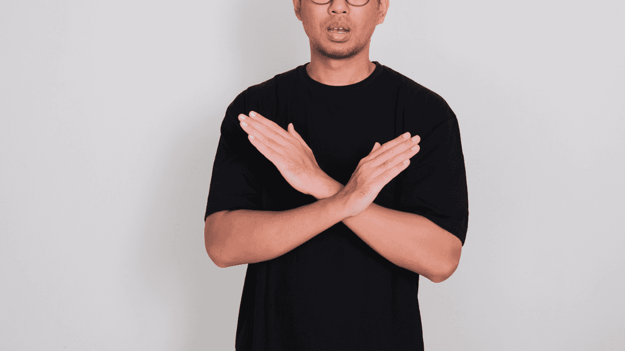 A man crossing his arms in front of his chest.