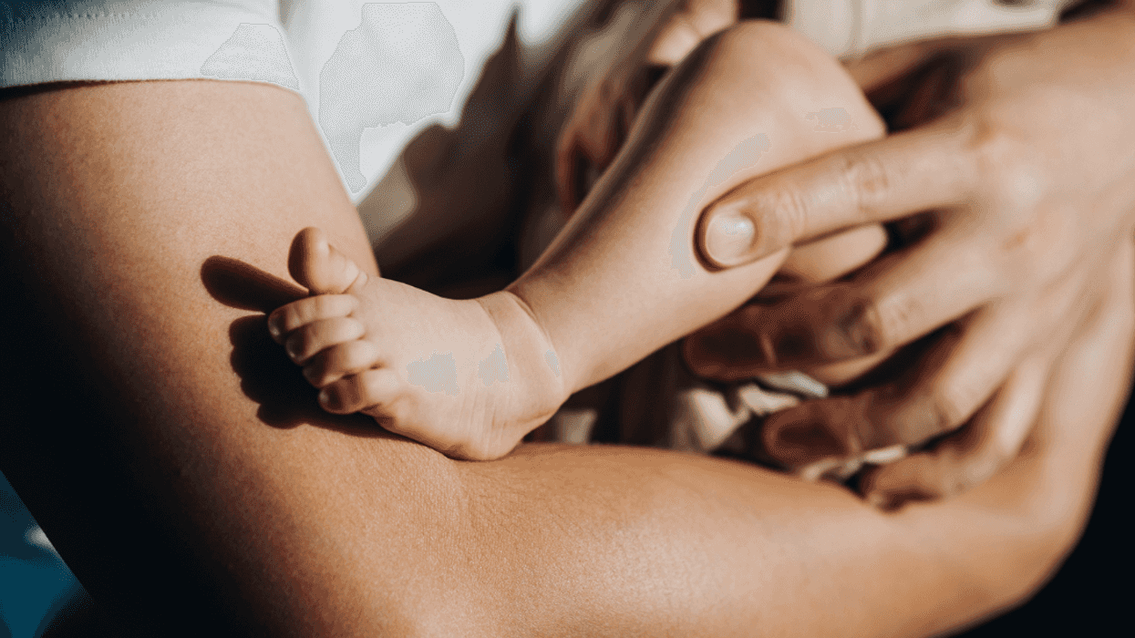 A man holding a baby in his arms.