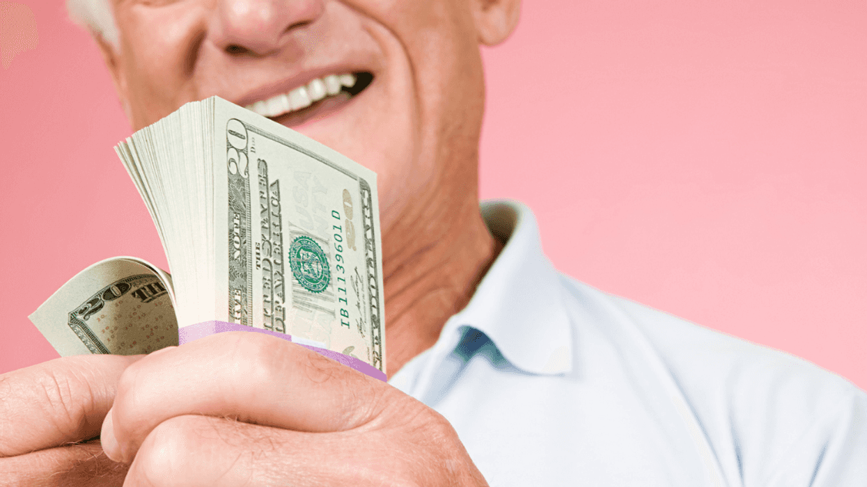 A man holding a wad of cash.