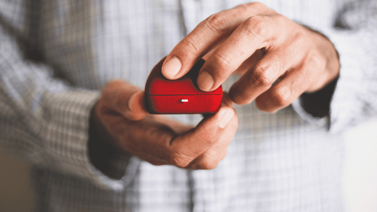 A man holding an engagement ring.