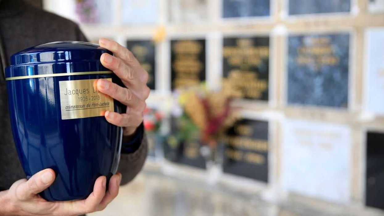 A man holding an urn