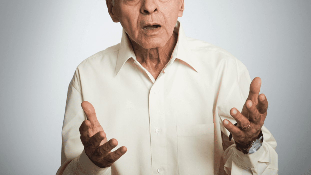 A man holding his hands out in.