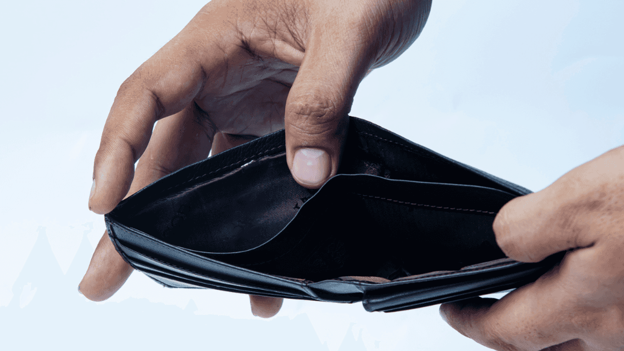 A man opening an empty wallet.