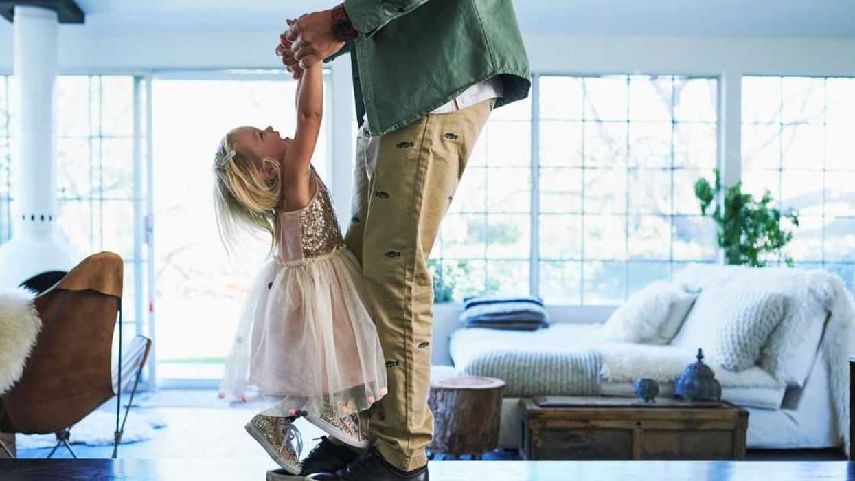 A man plays with a young girl