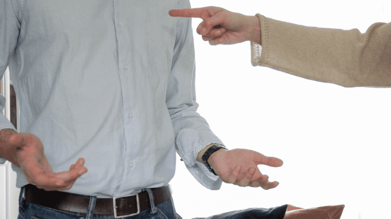 A man pointing his finger at another man.