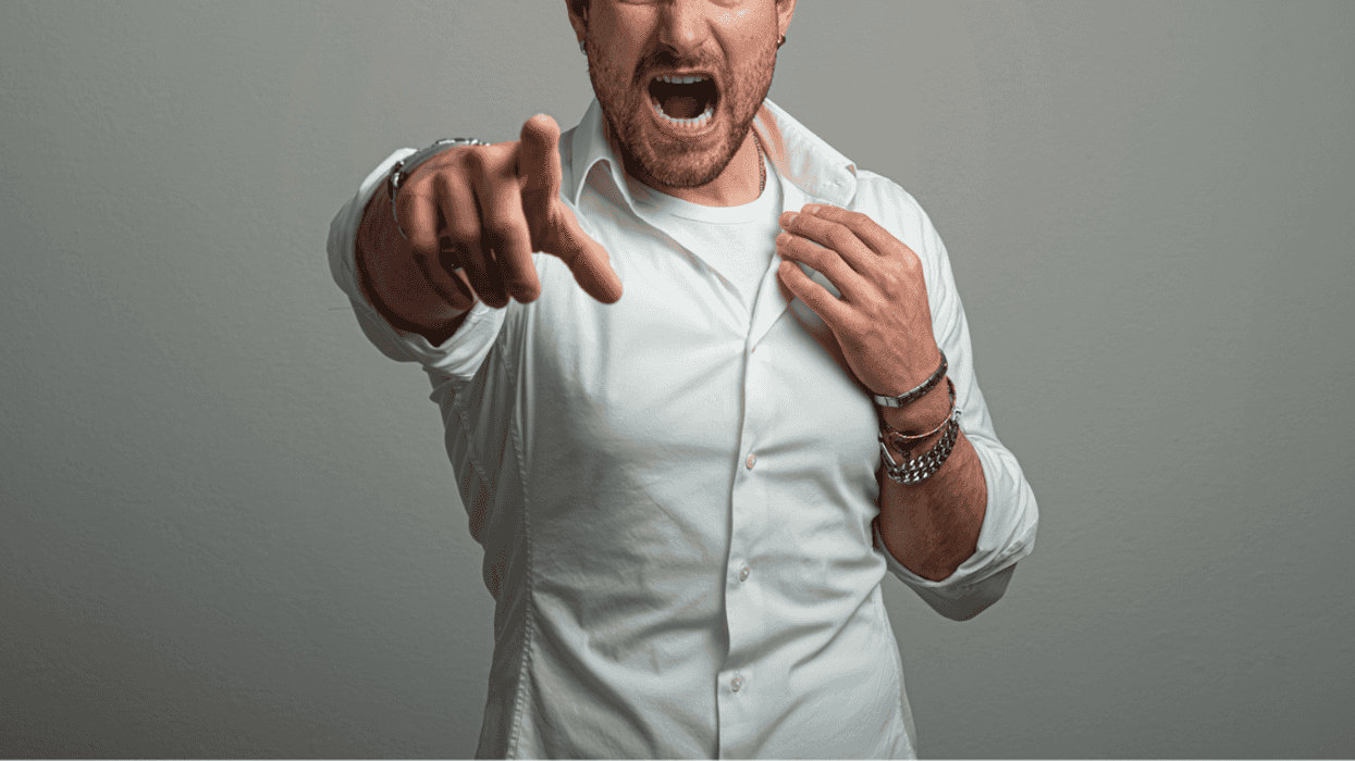 A man screaming and pointing his finger at the camera.
