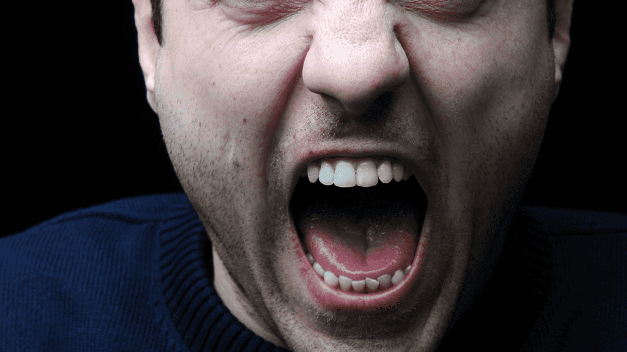 A man screaming with his mouth wide open.