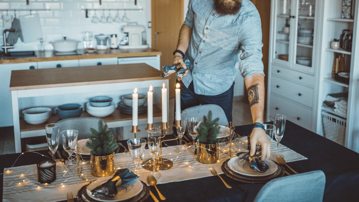 A man setting the table.