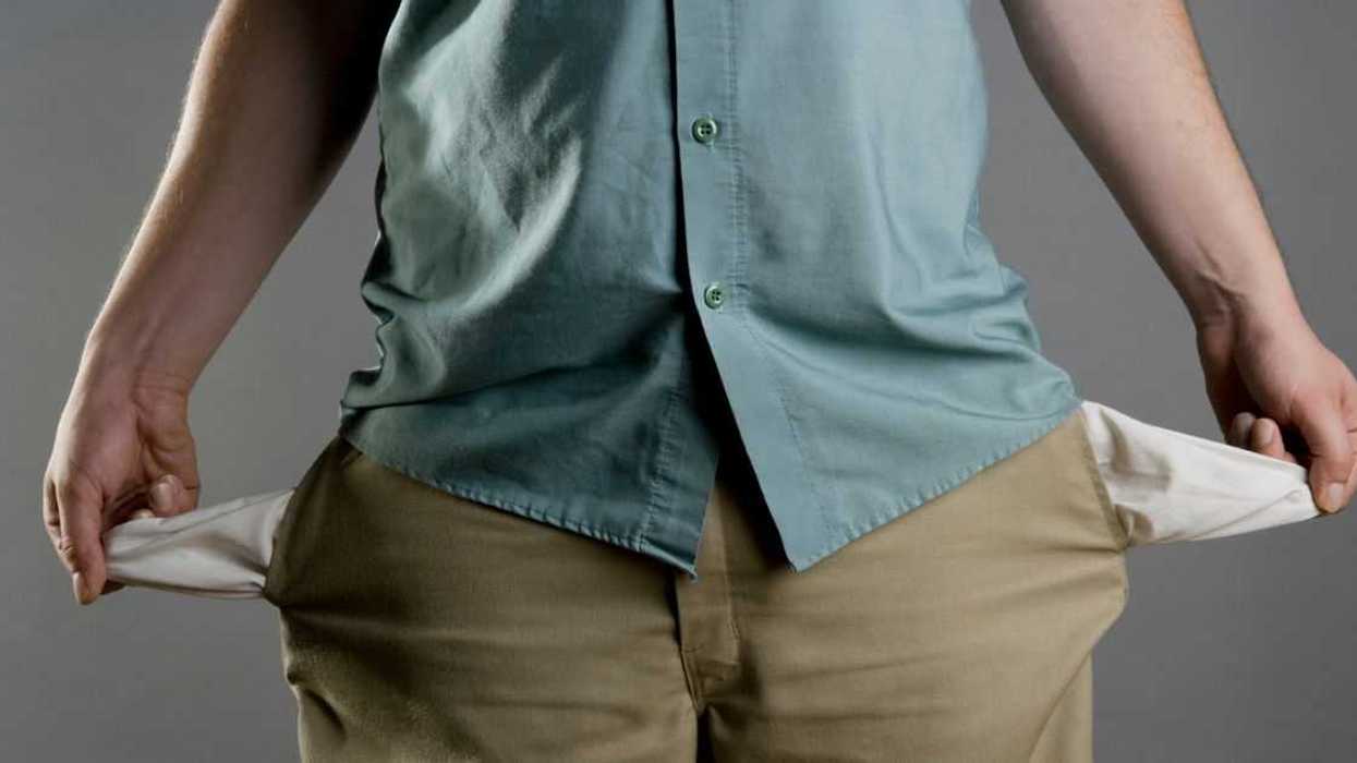 A man showing his empty pockets.