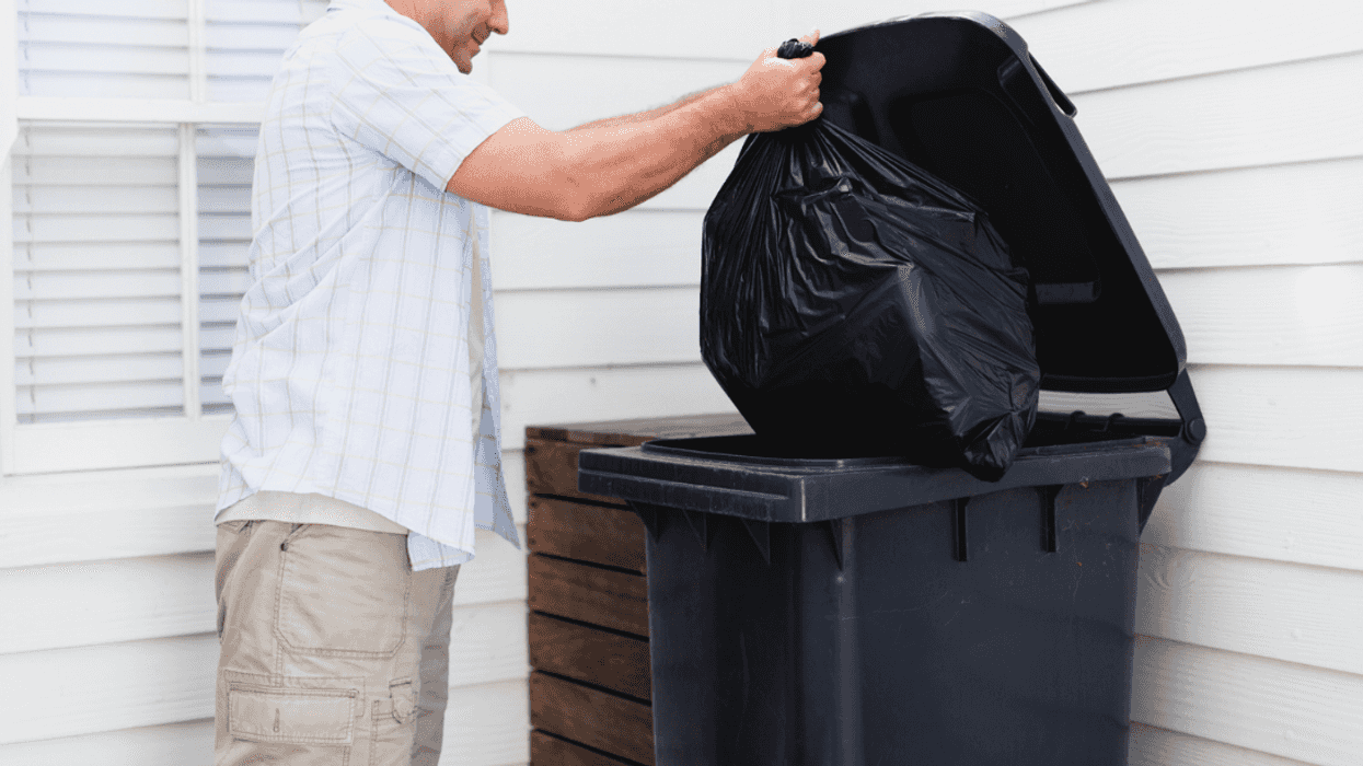A man taking out the trash.
