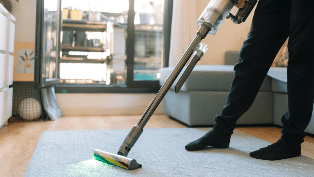 A man vacuumming