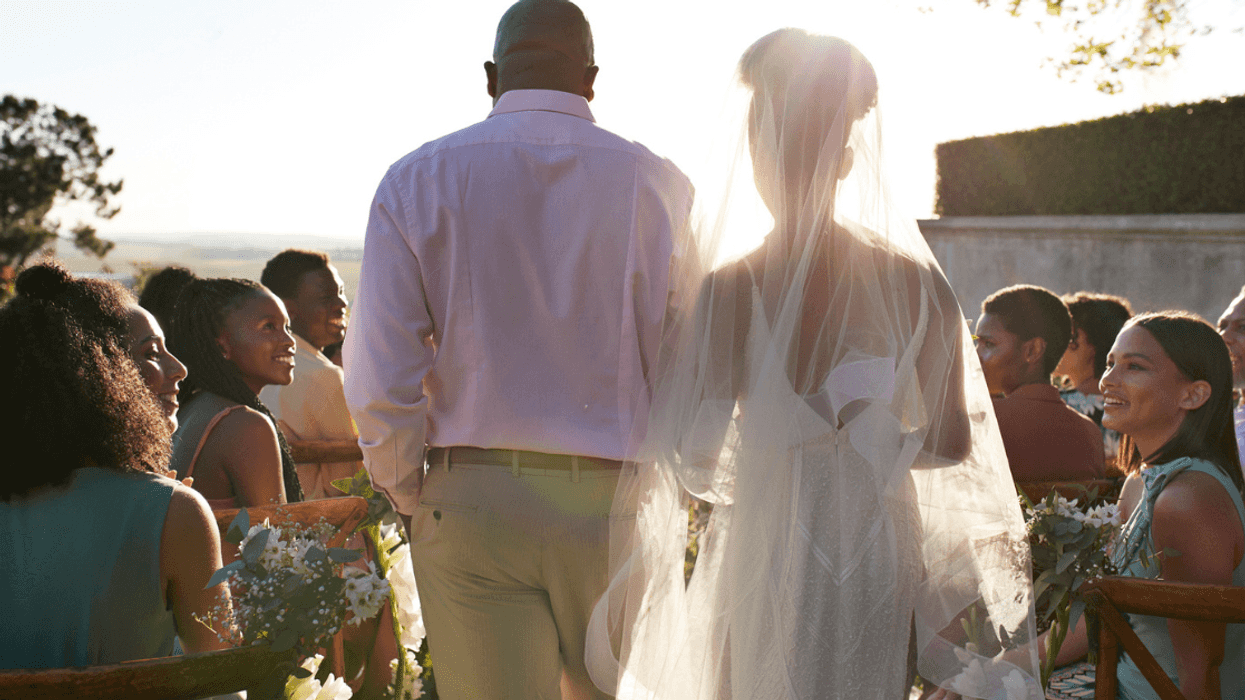A man walking a bride down the aisle.