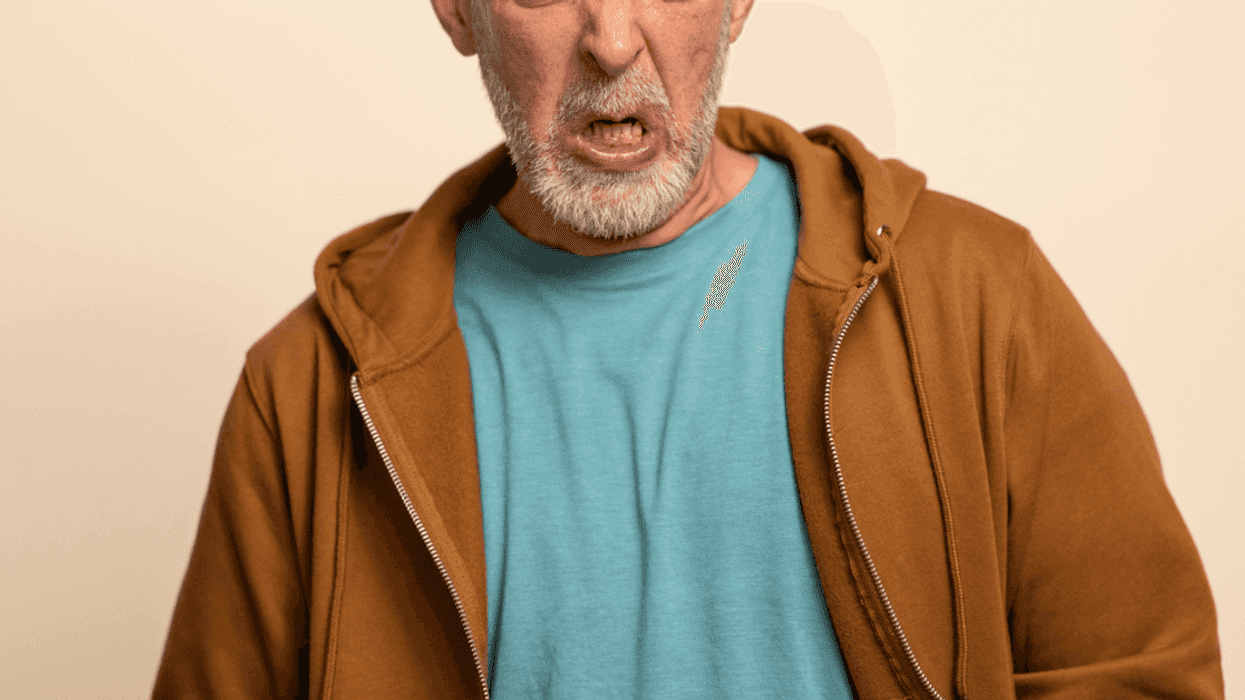 A man. with a disgruntled expression on his face.