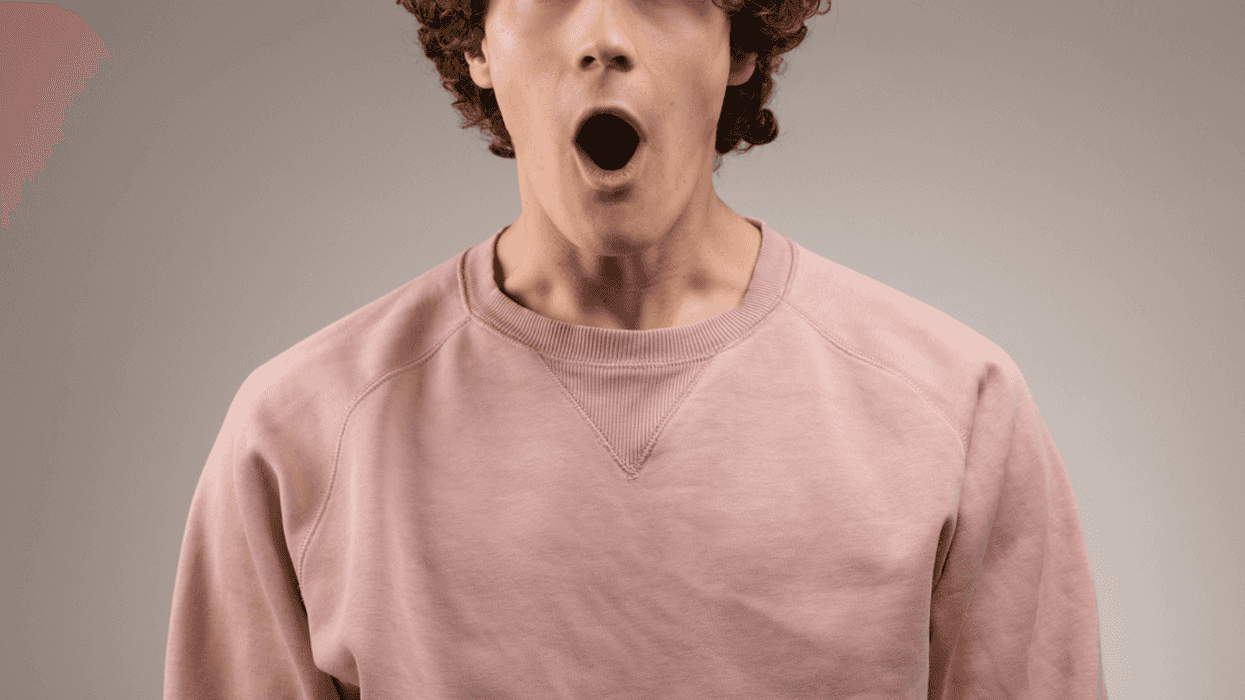 A man with facing forward with his mouth wide open.