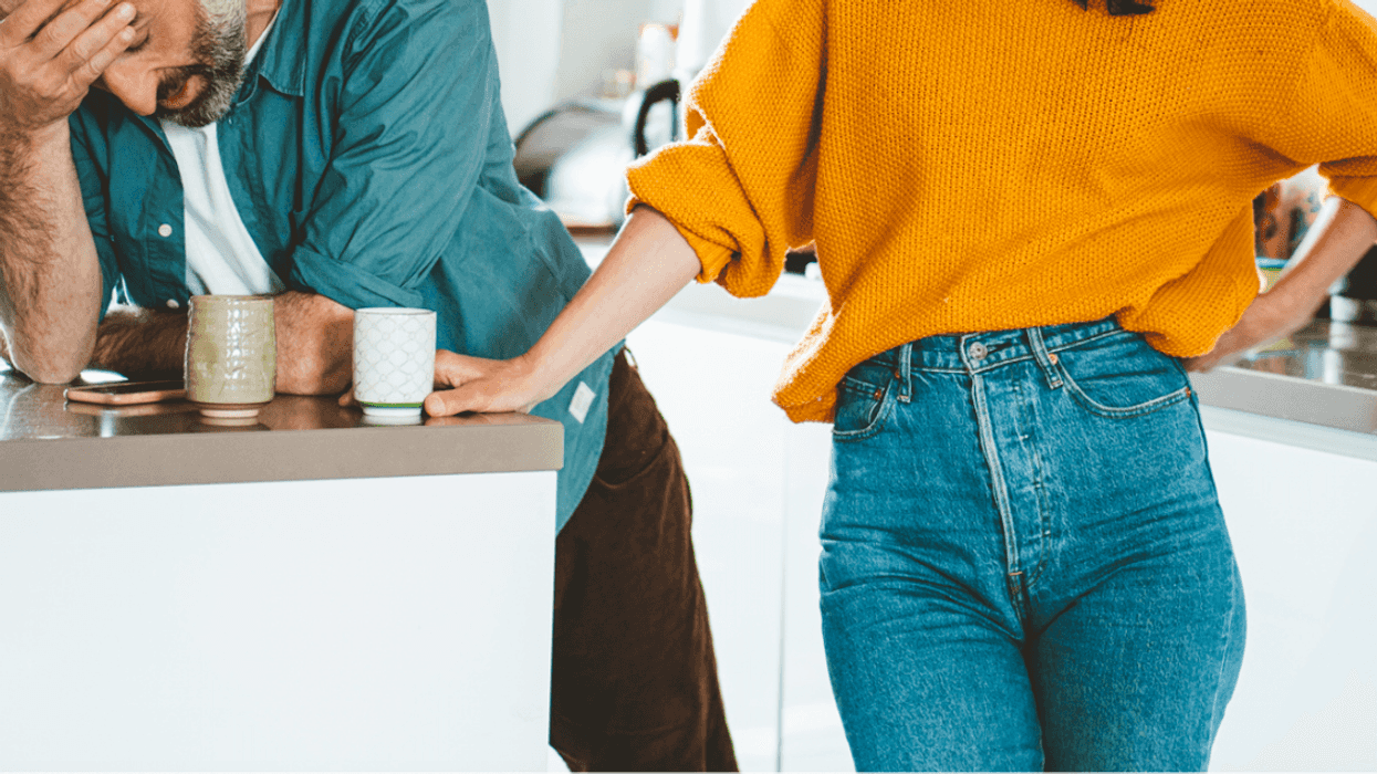 A man with his head in his hands and a woman with her arm on her hip.