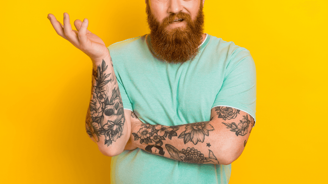A man with tattoos on his arms.