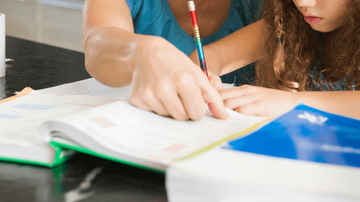 A mom teaches her daughter at home
