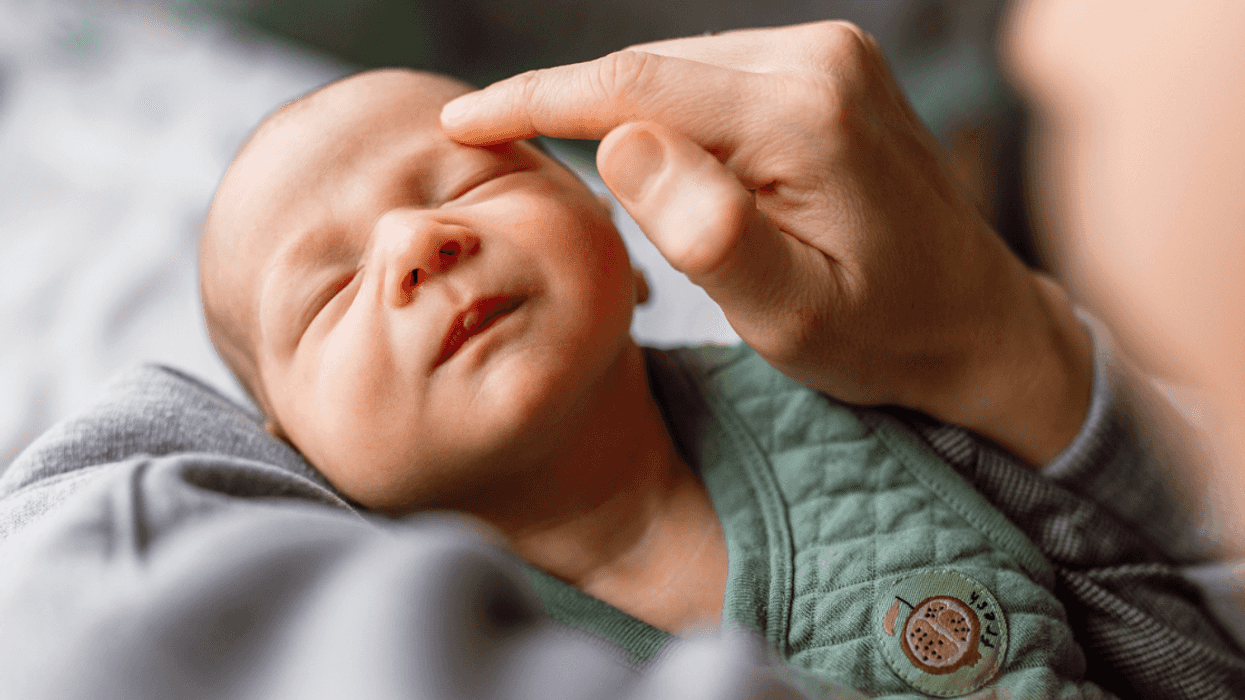 A mother holding a baby.