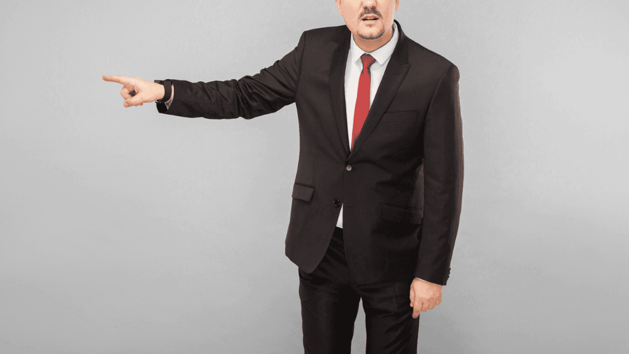 A pan pointing for someone to go.