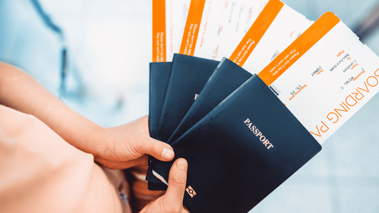 A person holding a fan of passports.