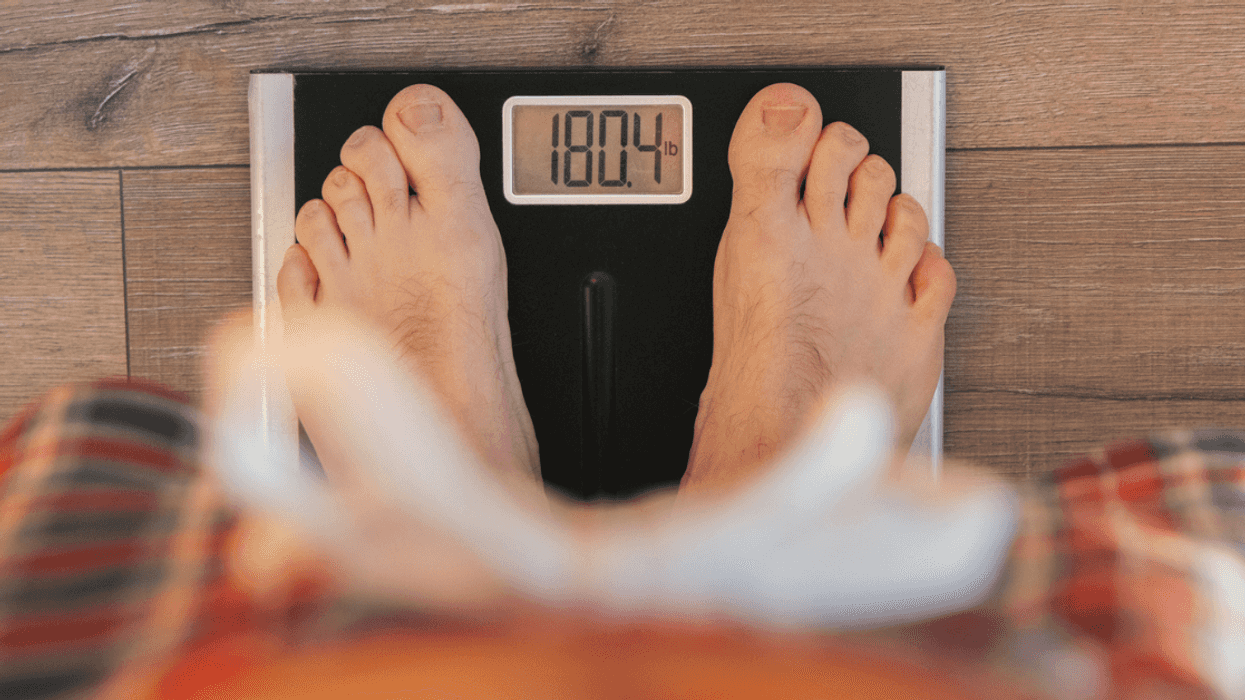 A person standing on a scale.