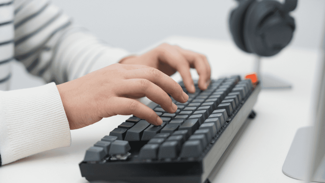 A person typing on a keyboard.
