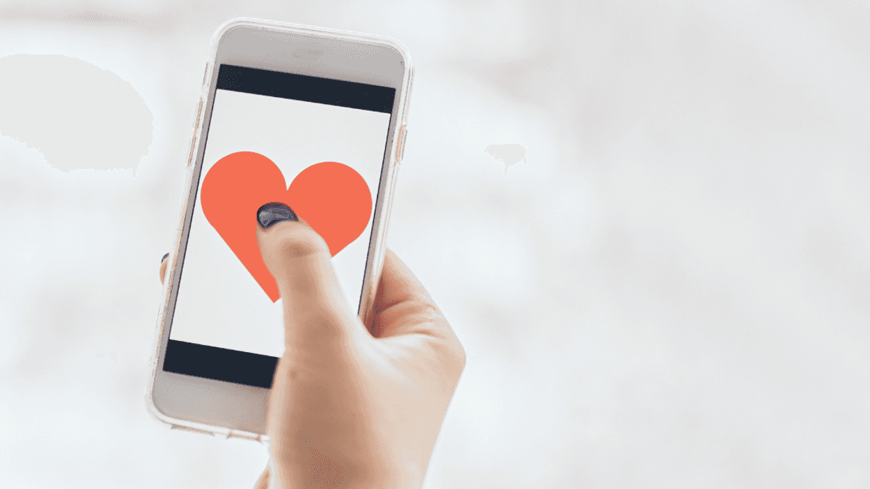 A person with a dating app open on their phone.